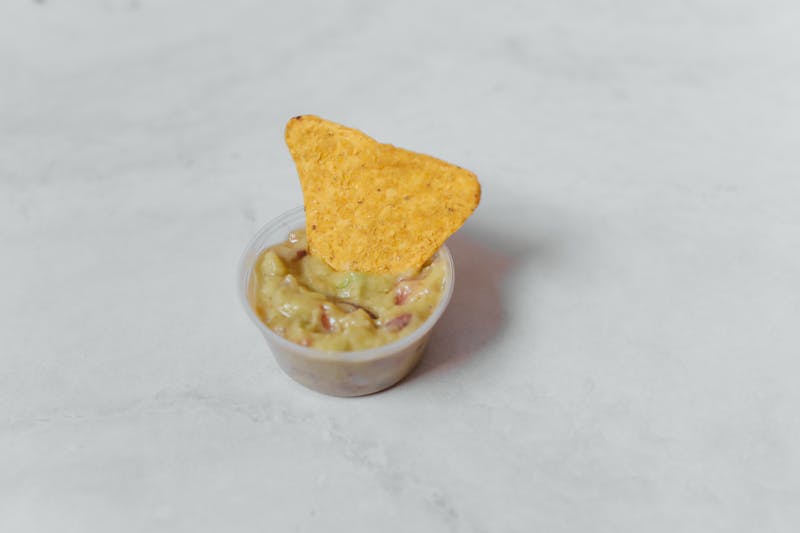 Loaded nachos with guacamole and salsa